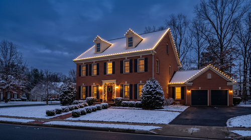 Brick colonial at dusk with warm white C9 roofline lights